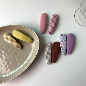 Detail shot of pastel plaid and solid fabric BB hair clips in various candy colors