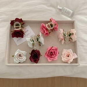 Detailed macro view of artificial silk rose hair claws in various romantic colors