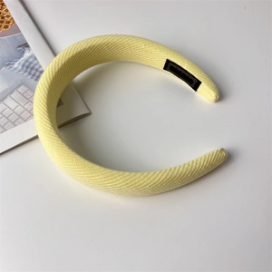 Detail view of pale yellow thick sponge headband with premium vertical ribbed texture