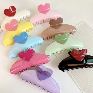 Close-up of colorful heart claw clips with smooth resin finish and strong metal spring