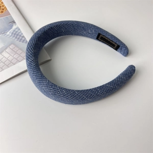 Detail of navy blue twill fabric padded headband showing thick texture and inner label