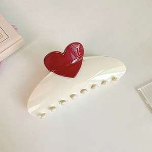 Detailed macro view of 13cm oversized cream hair claw clip with a red heart accent