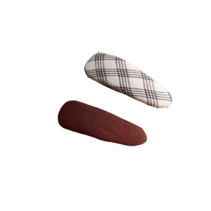 Set of two fabric hair clips featuring brown twill and classic houndstooth checkered patterns
