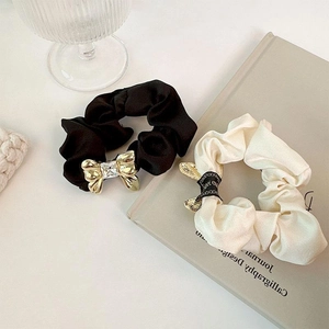 Elegant satin hair scrunchies set featuring golden metal bow with sparkling crystals