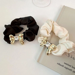 Elegant satin scrunchies set in black and cream with sparkling metal bow and crystal detail