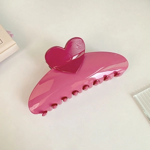 Detail of rose pink heart hair claw clip with glossy resin finish for women hairstyles