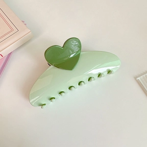 Macro shot of 13cm oversized light green hair claw with dark green heart details