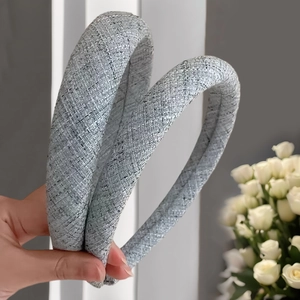 Thick light blue padded headband with woven texture for a high-volume hair look