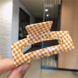 Détail de la grande pince à cheveux rectangulaire à carreaux jaunes et blancs