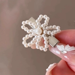Détail de la pince à cheveux fleur en perles tressées avec base en métal argenté