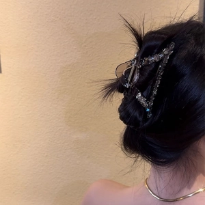 Elegant geometric hair claw clip with sparkling rhinestones on dark brown base