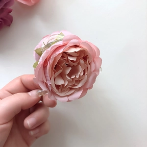 Pink realistic rose hair claw clip for women featuring elegant layered fabric petals