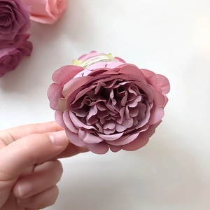 Close-up of small vintage purple rose hair claw clip with multi-layered silk petals