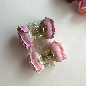 Elegant 45-degree view of pink rose floral hair claw clip made of acrylic material