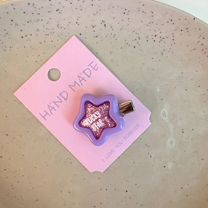 Detail of purple Y2K star hair clip with pink sequins and Lucky Star text engraving
