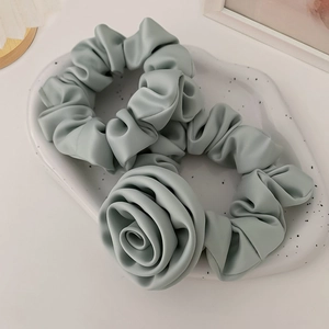 Mint green satin scrunchie set featuring a standard pleated ring and a 3D rose flower design