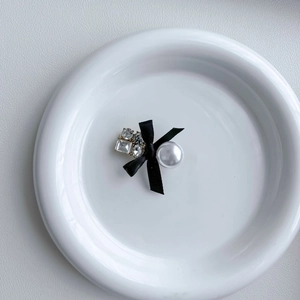 Elegant black bow hair clip with a large pearl and sparkling zircon rhinestones