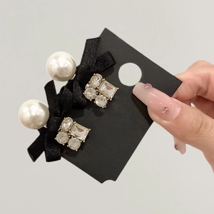 Elegant pearl and black silk bow earrings set with sparkling zircon crystal accents
