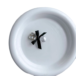 Elegant black bow hair clip with sparkling zircons and a large white pearl detail