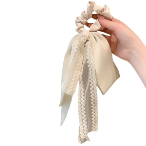 Elegant cream lace bow scrunchie with a pearl accent and long flowing ribbons