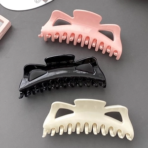 Oversized French plastic hair claws in pink black and cream white for thick hair