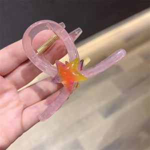 Pink heart-shaped claw clip with star accent and jelly texture for cute hair styling