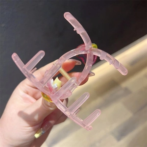Pink jelly heart hair claw clip with colorful gradient hearts and golden spring