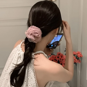 Pink chiffon rose flower hair scrunchie shown on low ponytail for elegant Korean style