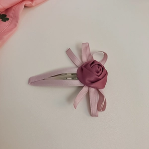 Rosafarbene Haarspange mit Satinrose und Schleife für elegante Damenfrisuren