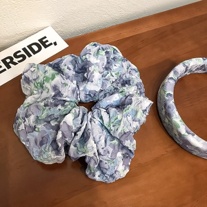 Blue floral scrunchie and wide headband set with crinkle texture on vintage wood