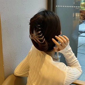 Close-up of a large amber translucent octopus hair claw clip for elegant updo hairstyles