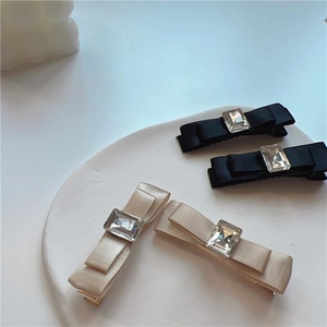 Elegant satin bow hair clips with square crystal centers in black and champagne