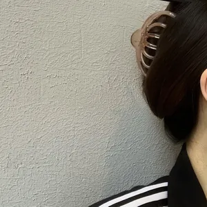 Close-up of elegant coffee brown octopus claw clip securing a French style hairstyle