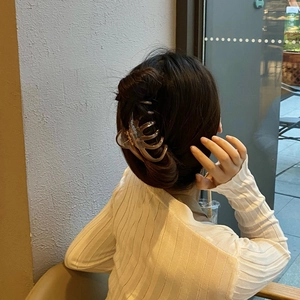 Detailed view of amber octopus hair claw clip for elegant French bun styling