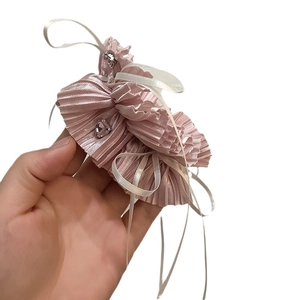 Pink pleated fabric hair tie with white ribbon bow and crystal heart charm decoration