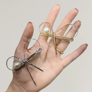Elegant metallic bow hair clip with pearls and rhinestones in gold and silver set