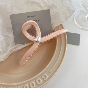 Elegant pale pink heart claw clip with silver accents for sophisticated hair styling