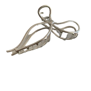 Elegant silver metal bow shark clip with multi-row teeth for thick hair in minimalist style