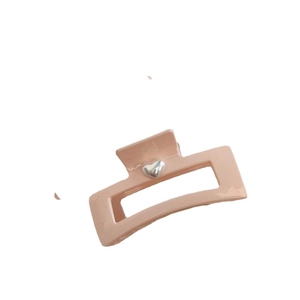 Minimalist pink matte hair claw clip with silver 3D heart detail for elegant hair styling