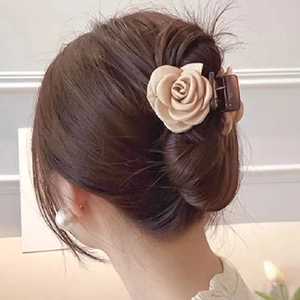 Elegant champagne satin flower hair claw clip accessory worn on a soft hairstyle
