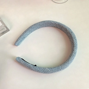 Close-up of blue tweed padded headband with anti-slip lining and thick sponge texture