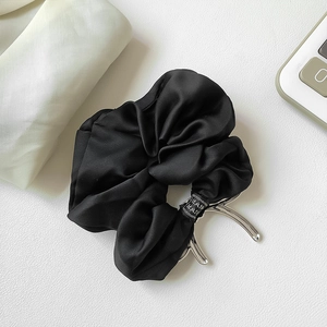 Elegant black satin scrunchie claw clip with glossy silk texture for hair styling