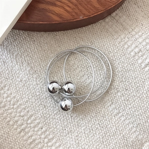 Three-piece silver hair tie set with polished metallic beads on elastic cords
