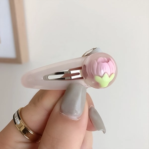 Dettaglio di un fermaglio per capelli a tulipano rosa con fiore 3D in una cupola