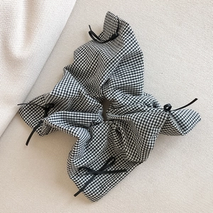 Classic black and white checkered scrunchie with delicate black ribbon bows hair accessory