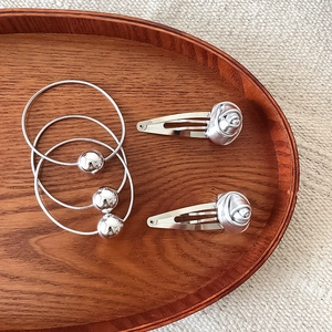 Chic silver rose hair clip set with metallic beads on elastic ties in a wood tray