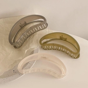 Three-piece set of large crescent hair claws in smoke grey, olive green, and cream white matte