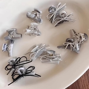 Silver bow mini hair claws with elegant marble acetate texture for women's hair styling