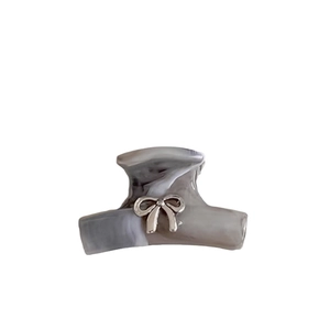 Silver bow hair claw clip with grey marble texture finish for elegant styling