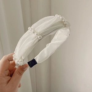 Elegant white pleated fabric headband with faux pearl accents for women
